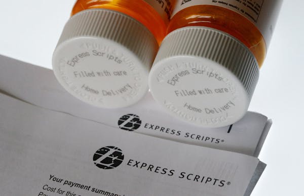 FILE - In this July 25, 2017, file photo, Express Scripts prescription medication bottles are arranged for a photo in Surfside, Fla. Health insurer Ci