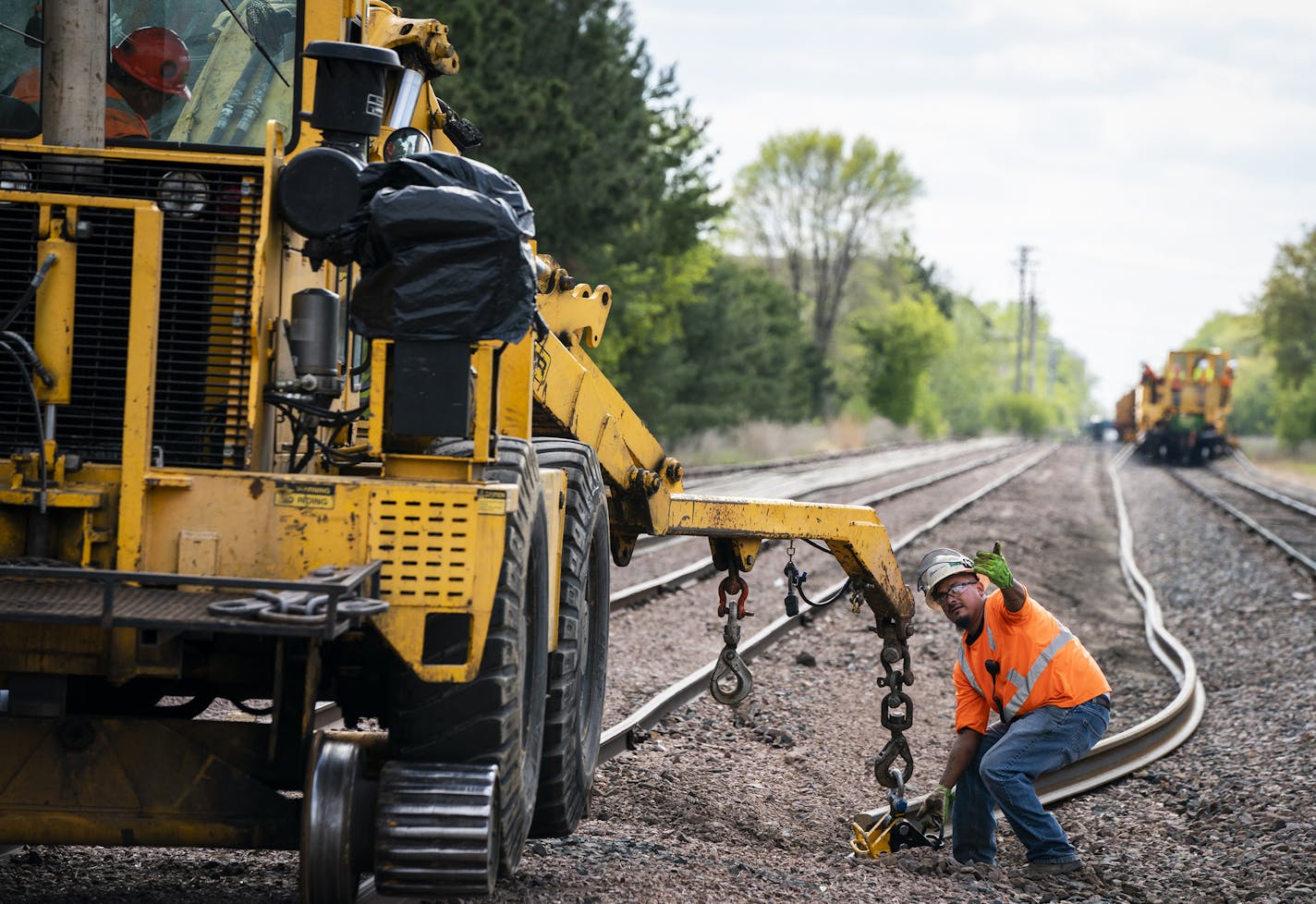 Workers unloaded and placed rail segments for the Southwest light rail near the future Beltline Boulevard station in St. Louis Park on Monday.