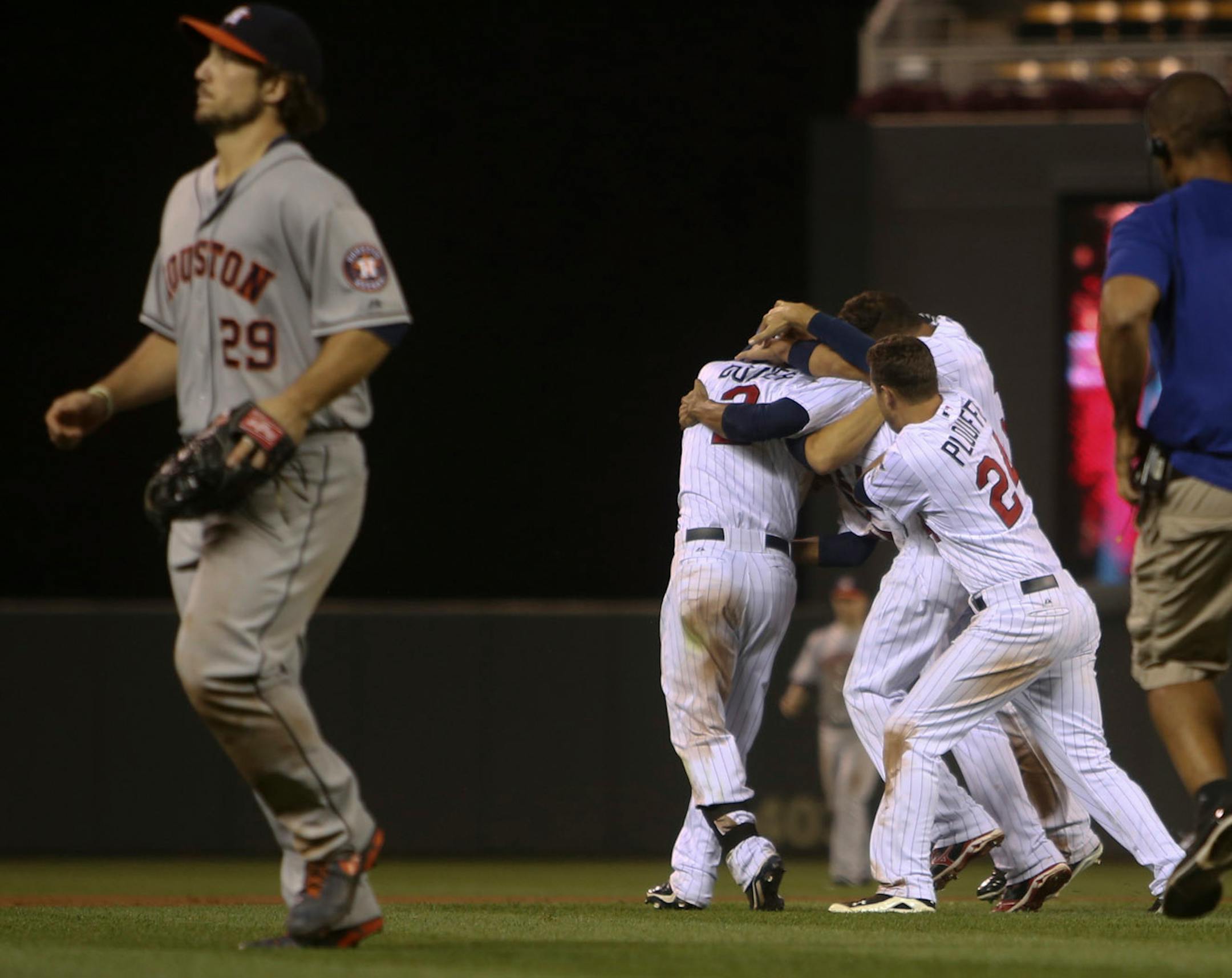 Minnesota Twins players mob Brian Dozier after his single lifted the Twins over the Houston Astros 4-3 in 13 innings Friday, August, 2, 2013, at Target Field in Minneapolis, MN.](DAVID JOLES/STARTRIBUNE) djoles@startribune.com Houston Astros and the Minnesota Twins Friday, August, 2, 2013, at Target Field in Minneapolis, MN.