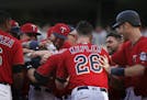 Brian Dozier(2) is greeted by the Twins player for hitting the game winning grand slam to end the game in the 10 innings.] Twins face the Rays on 7/16