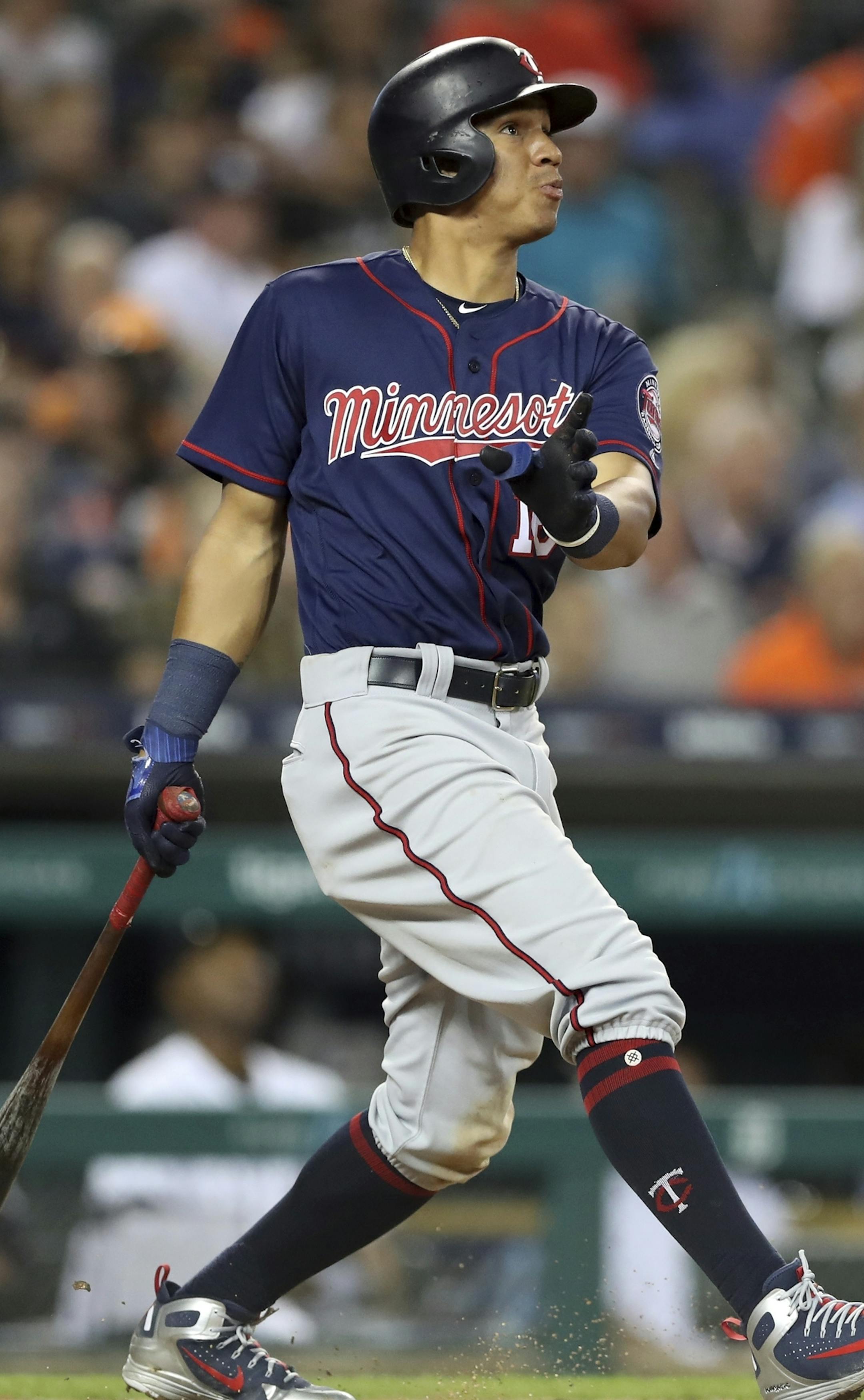 Minnesota Twins' Ehire Adrianza follows through on his grand slam during the seventh inning of a baseball game against the Detroit Tigers, Tuesday, June 12, 2018, in Detroit. (AP Photo/Carlos Osorio)