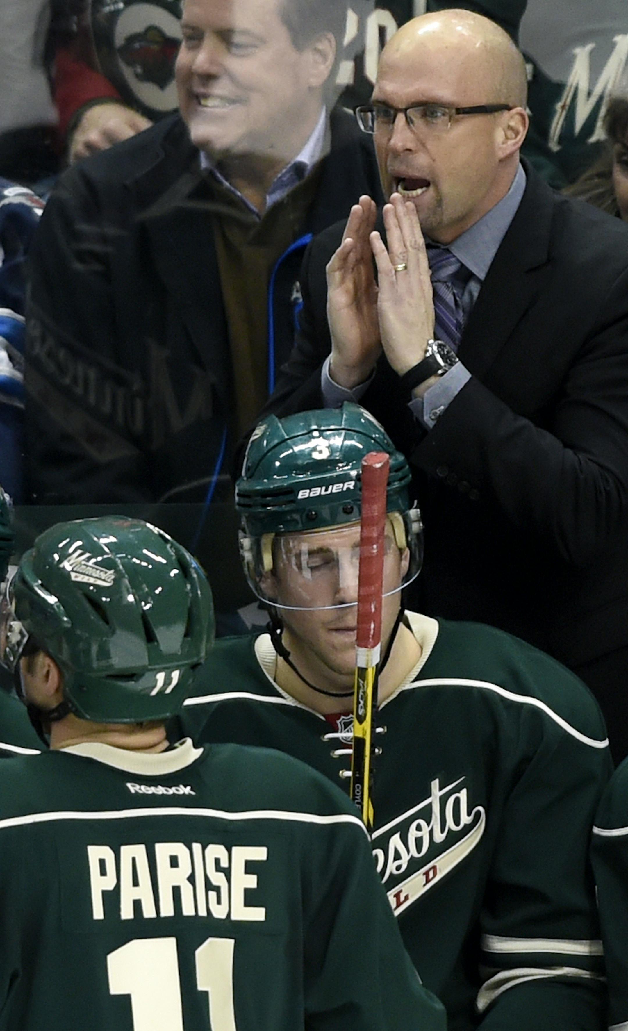 Minnesota Wild head coach Mike Yeo, upper right, speaks to his players during the third period of an NHL hockey game against the Winnipeg Jets, Friday, Jan. 15, 2016, in St. Paul, Minn. The Jets won 1-0. (AP Photo/Hannah Foslien)