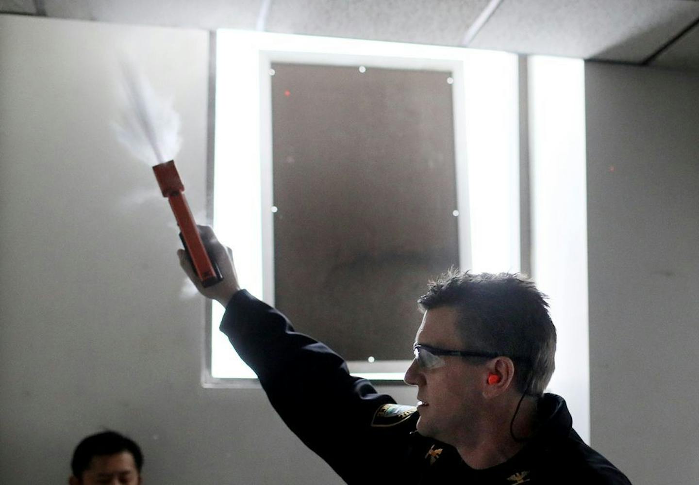 St. Paul Police Commander Kurt Hallstrom fires a marble-sized round of powder with a pepper irritant that breaks on impact and is effective as a measure of force by causing respiratory distress. Hallstrom used the PepperBall launcher at a downtown St. Paul Police Department training site Wednesday, Feb. 6, 209, in St. Paul, MN.