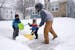 Ricky Bibuka got some help from his sons Kingston, 4, and Lachlan, 2, as he shoveled the sidewalk in front of their home Friday in northeast Minneapol