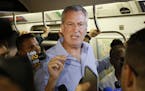 FILE - In this July 23, 2017 file photo, New York Mayor Bill de Blasio talks to reporters on the subway in New York. De Blasio wants to tax the wealth