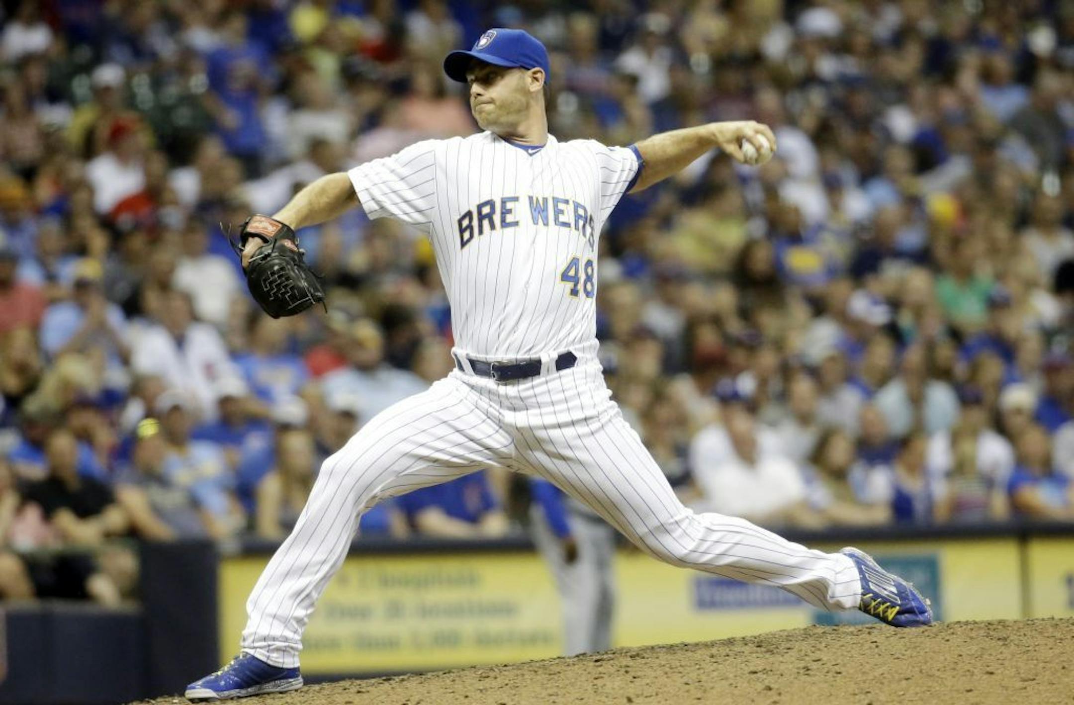 Milwaukee Brewers relief pitcher Neal Cotts throws during the sixth inning of a baseball game against the Chicago Cubs Friday, July 31, 2015, in Milwaukee.