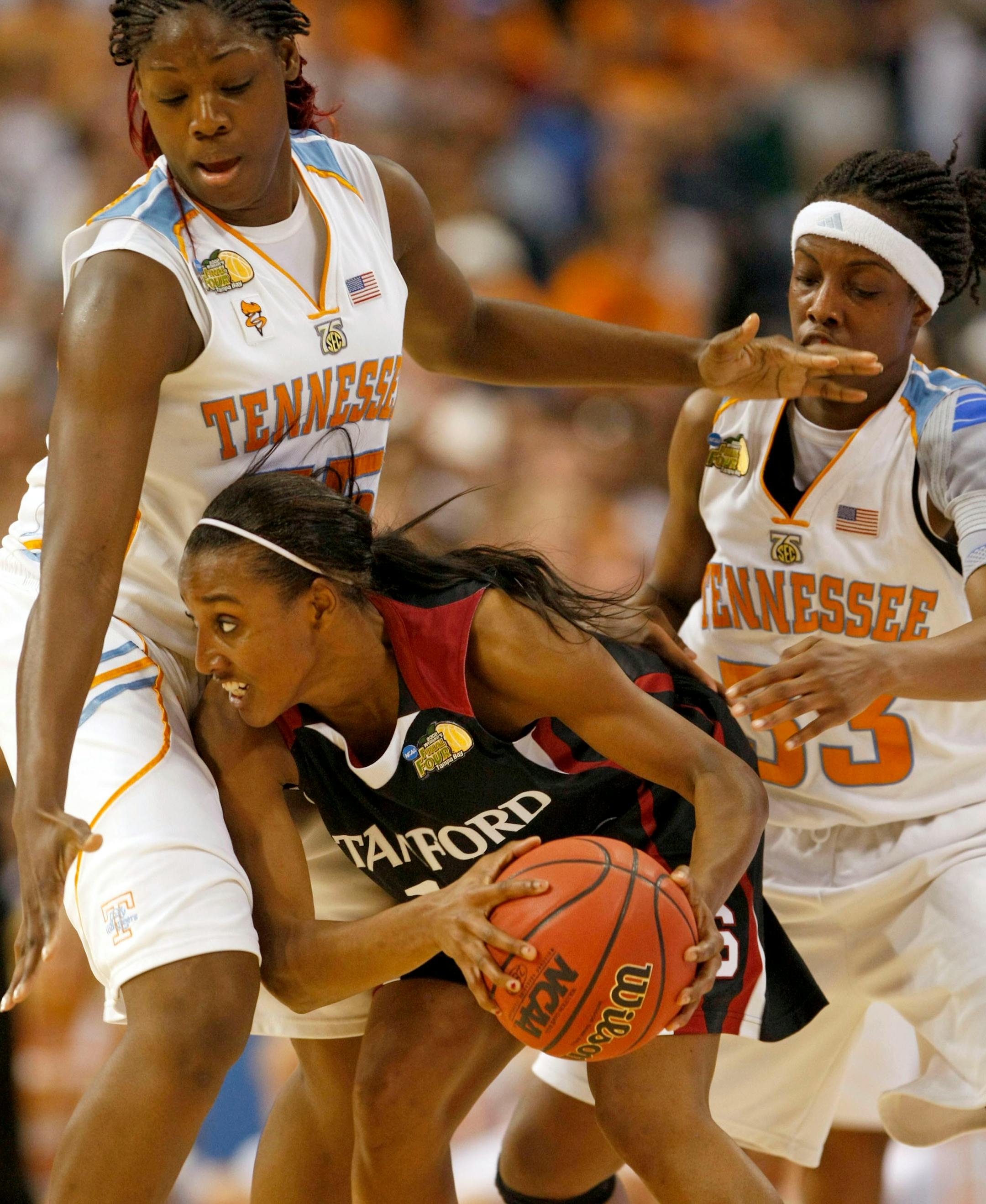 Stanford's Candice Wiggins (center) is tied up by Tennessee's Nicky Anosike and Alberta Auguste during the first half of the NCAA Women's Championship game at the St. Petersburg Times Forum in Tampa, Florida, Tuesday, April 8, 2008.
