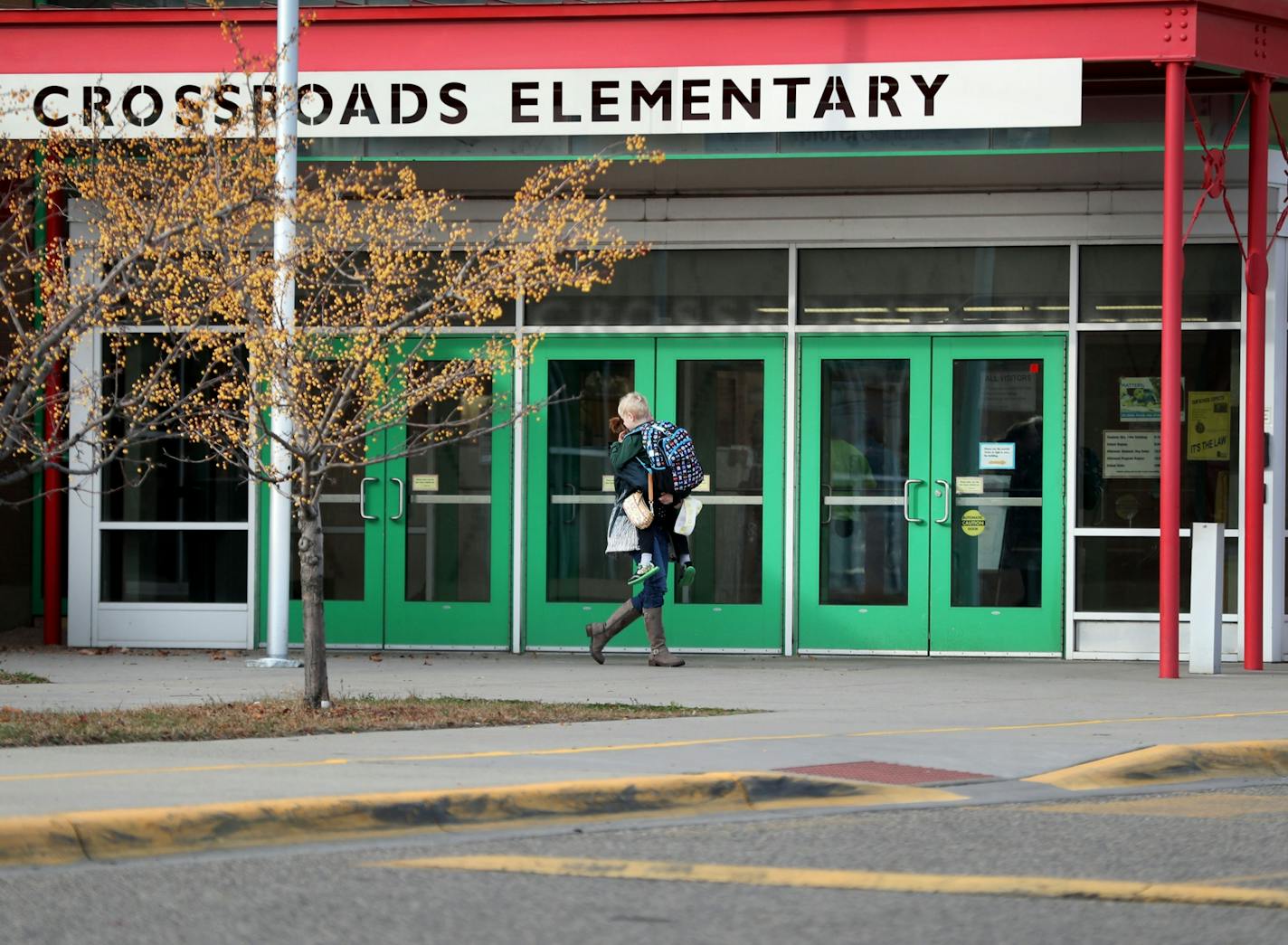 A loaded handgun brought to Crossroads Elementary School by a 7-year-old first-grade student discharged one round but no one was hurt Thursday in St. Paul. Here, parents pick up their children from the school Thursday afternoon.