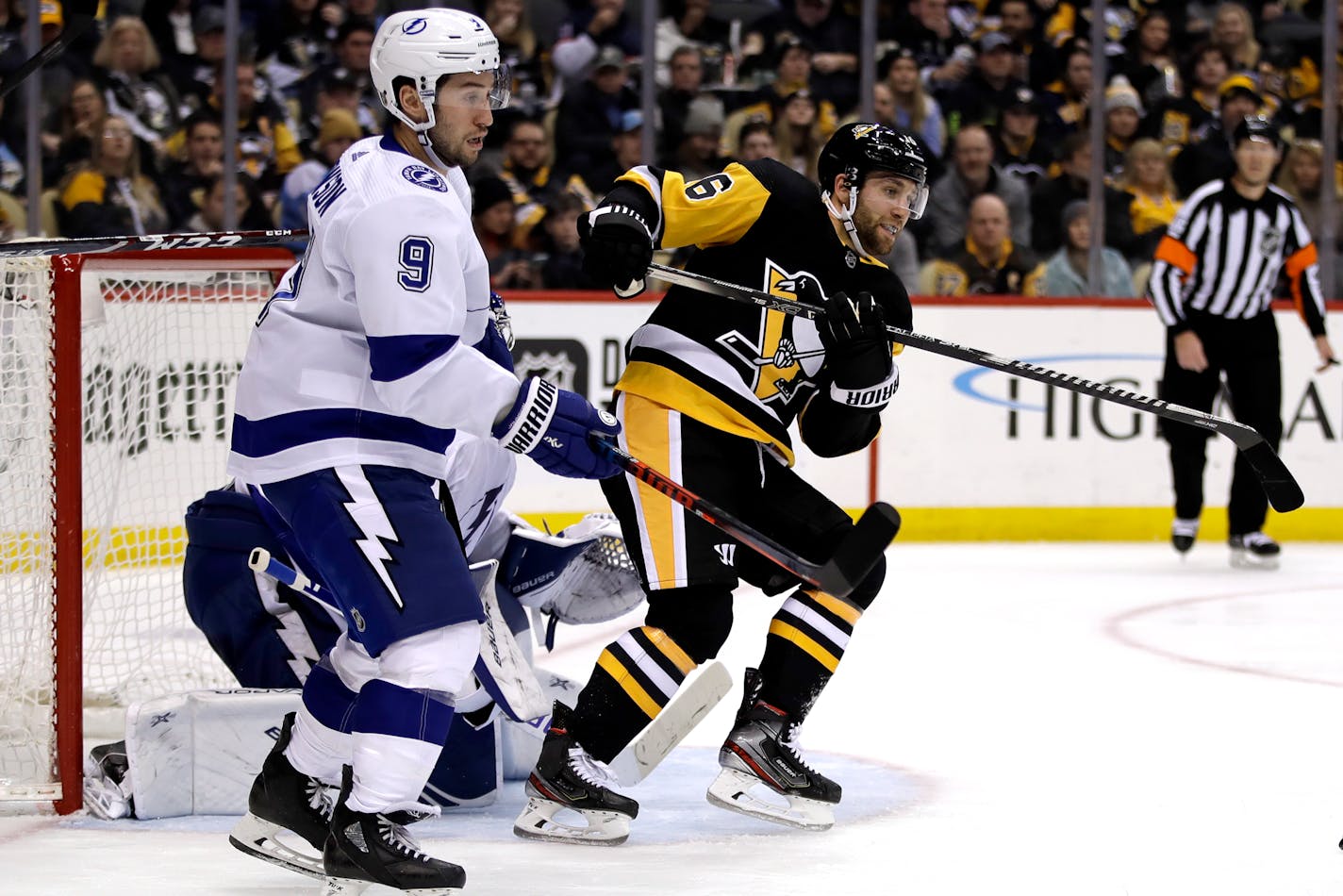 Pittsburgh Penguins' Jason Zucker (16) screens Tampa Bay Lightning goaltender Andrei Vasilevskiy with Tyler Johnson (9) defending during the second period of an NHL hockey game in Pittsburgh, Tuesday, Feb. 11, 2020. (AP Photo/Gene J. Puskar)