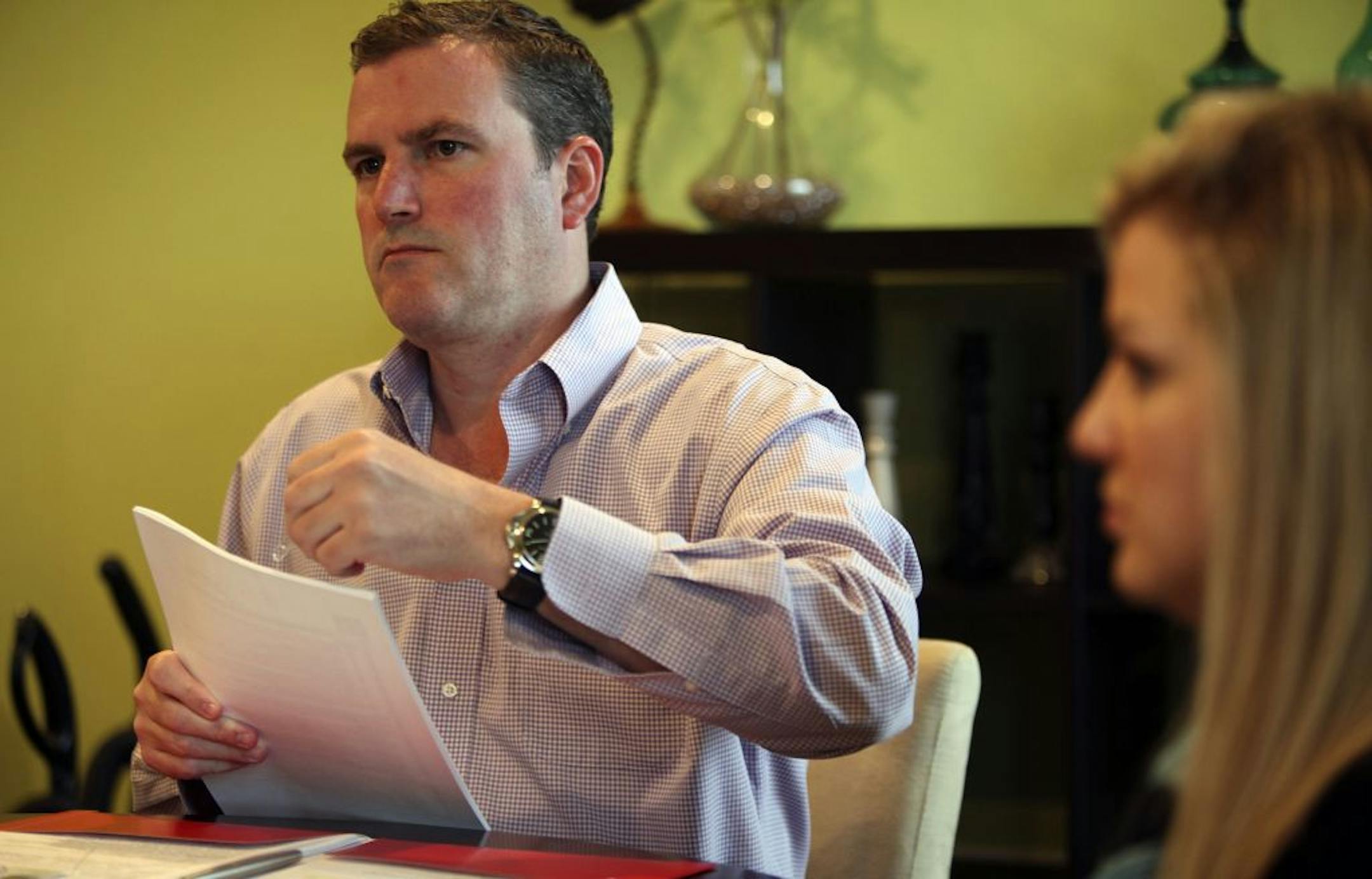 Chris Willette, of Edina Realty, listened to questions from sellers, Christie Colborn and Laura Schmaltz (not pictured) , in their Robbinsdale townhome.
