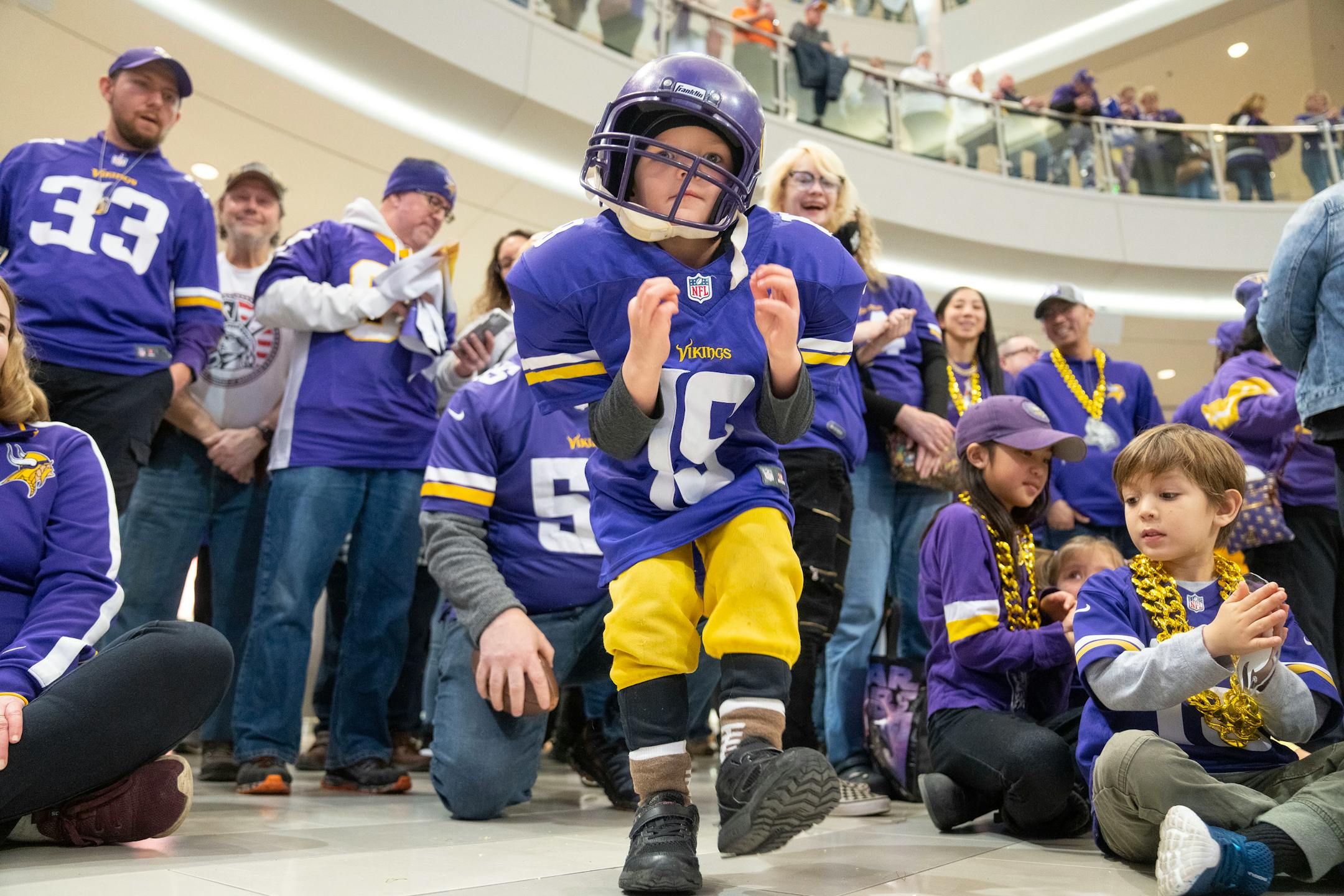 Elijah "bear" Young does the gritty in front of other fans during a Vikings fan rally.