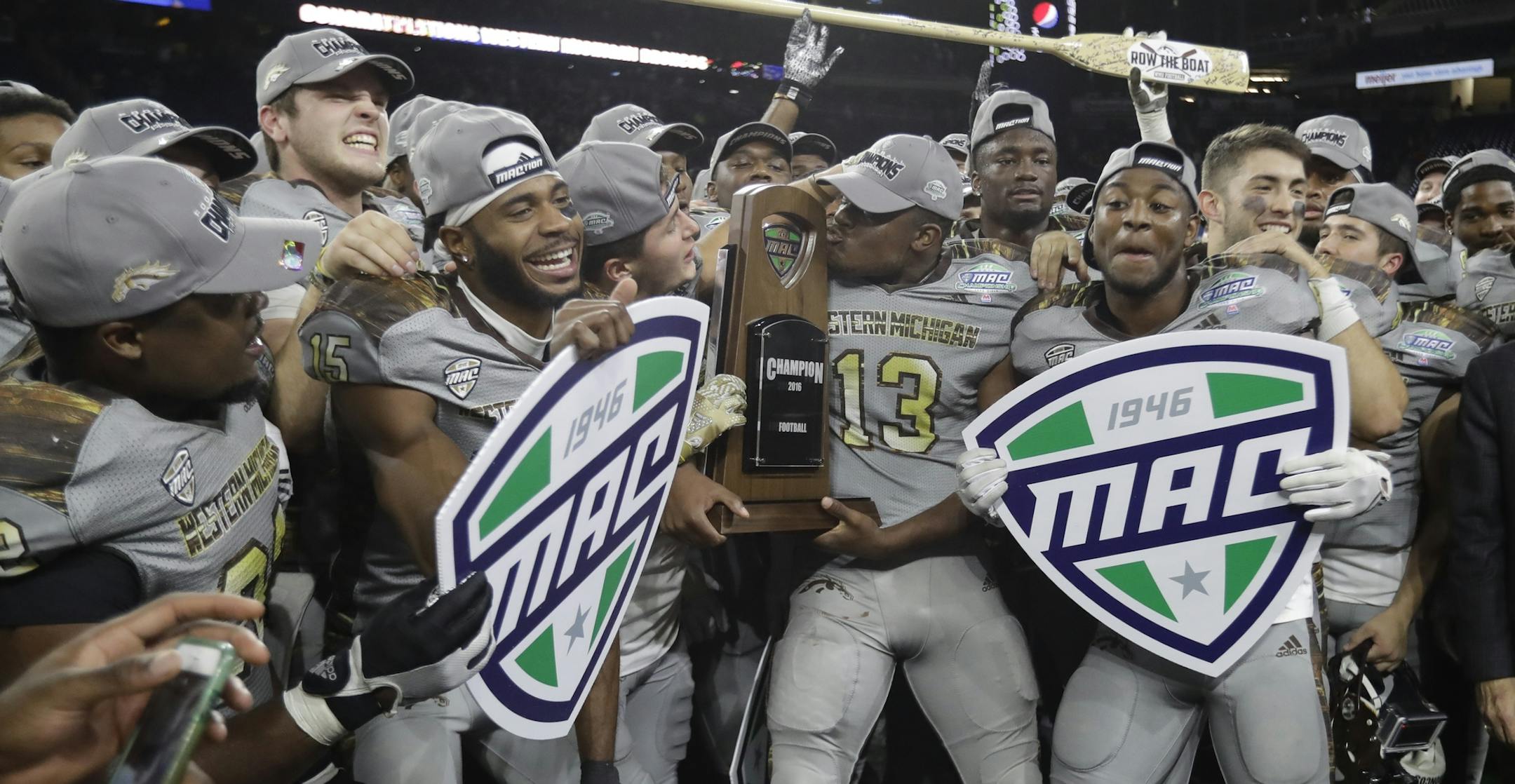 Western Michigan players celebrate their 29-23 win over Ohio in the Mid-American Conference championship NCAA college football game, Friday, Dec. 2, 2016, in Detroit. (AP Photo/Carlos Osorio)