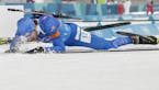 Leif Nordgren, of United States of America, collapses in the finish area after the men's 4x7.5-kilometer biathlon relay at the 2018 Winter Olympics in