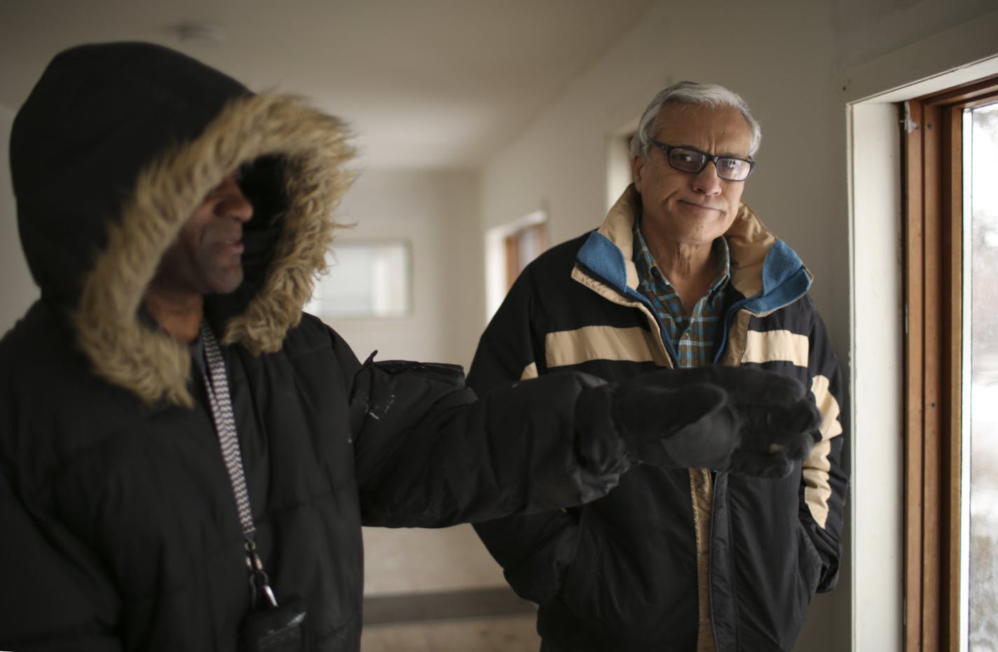 Mahmood Khan with a member of his maintenance crew, , left, in one of his former rental properties in north Minneapolis Monday afternoon.