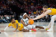 Gophers guard Elijah Hawkins, left, and teammate Parker Fox defend against Michigan State's Tre Holloman in Thursday's Big Ten tournament matchup.