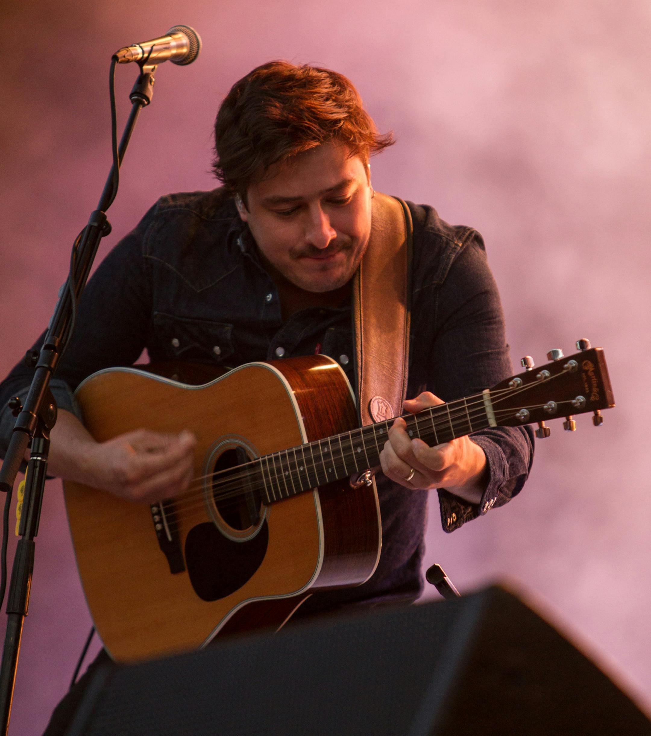 Marcus Mumford, lead vocalist of Mumford & Sons, performs at the Lollapalooza Festival in Chicago, Saturday, Aug. 3, 2013. The more than two-decade-old festival opened Friday in Chicago's lakefront Grant Park. (AP Photo/Scott Eisen)