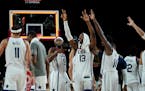United States players celebrate their win in the men's basketball semifinal game against Australia at the 2020 Summer Olympics