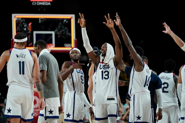 United States players celebrate their win in the men's basketball semifinal game against Australia at the 2020 Summer Olympics