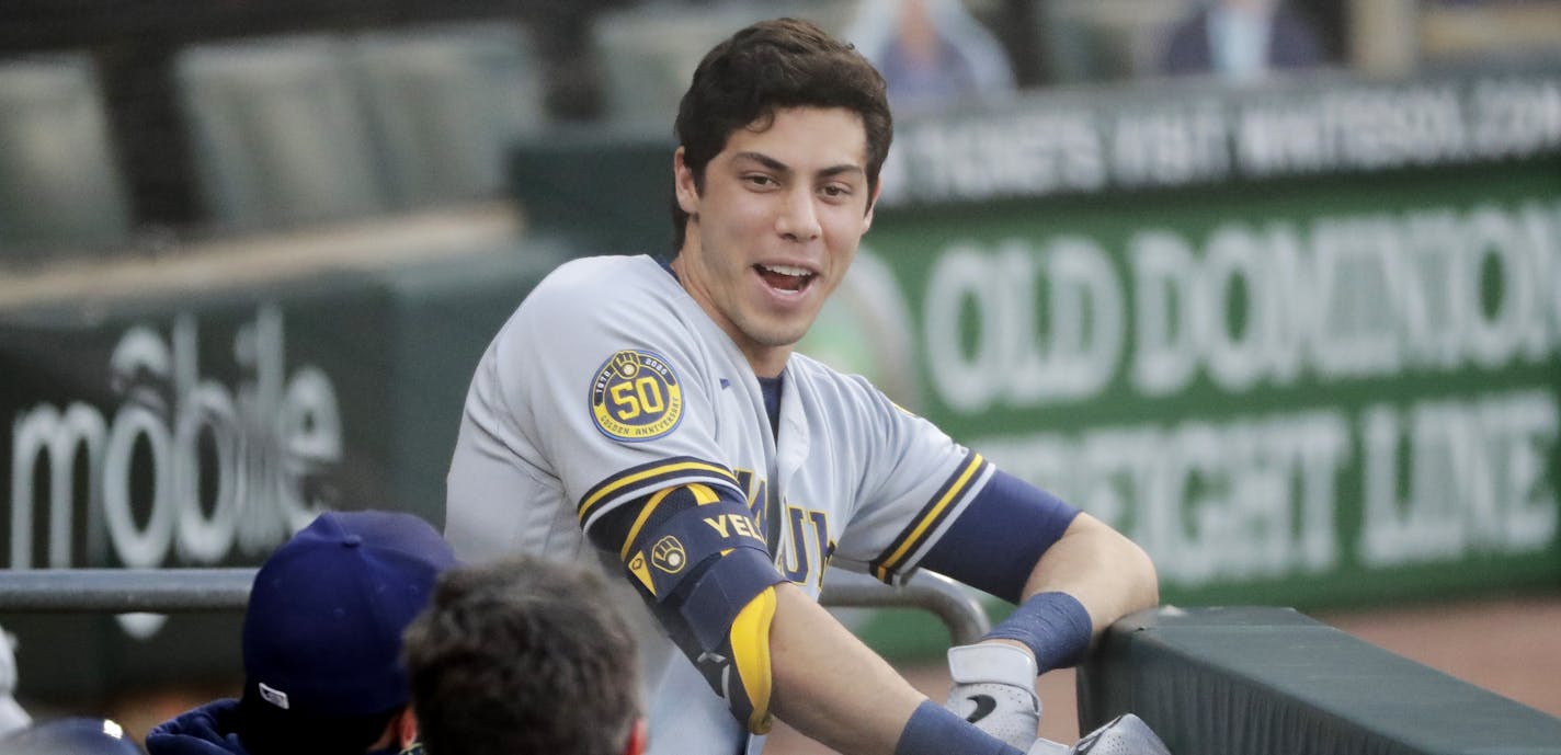 Milwaukee Brewers' Christian Yelich talks with coaching staffs before a baseball game against the Chicago White Sox during in Chicago, Thursday, Aug. 6, 2020. (AP Photo/Nam Y. Huh)