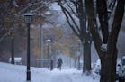 A pedestrian walks down a St. Paul street during the first snow of the winter in October of last year.