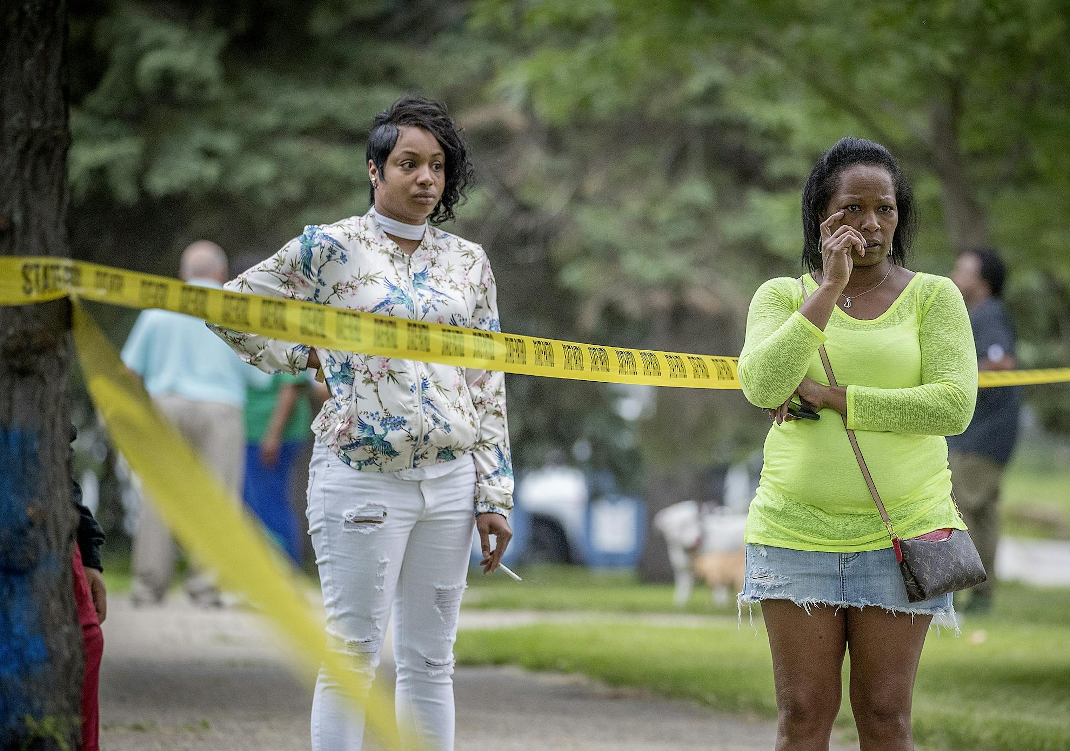 Bystanders watched as Minnesota State Patrol investigated the scene where a motorist being pursued by the State Patrol veered into a Minneapolis school playground and hit at least one child, Monday, June 11, 2018.