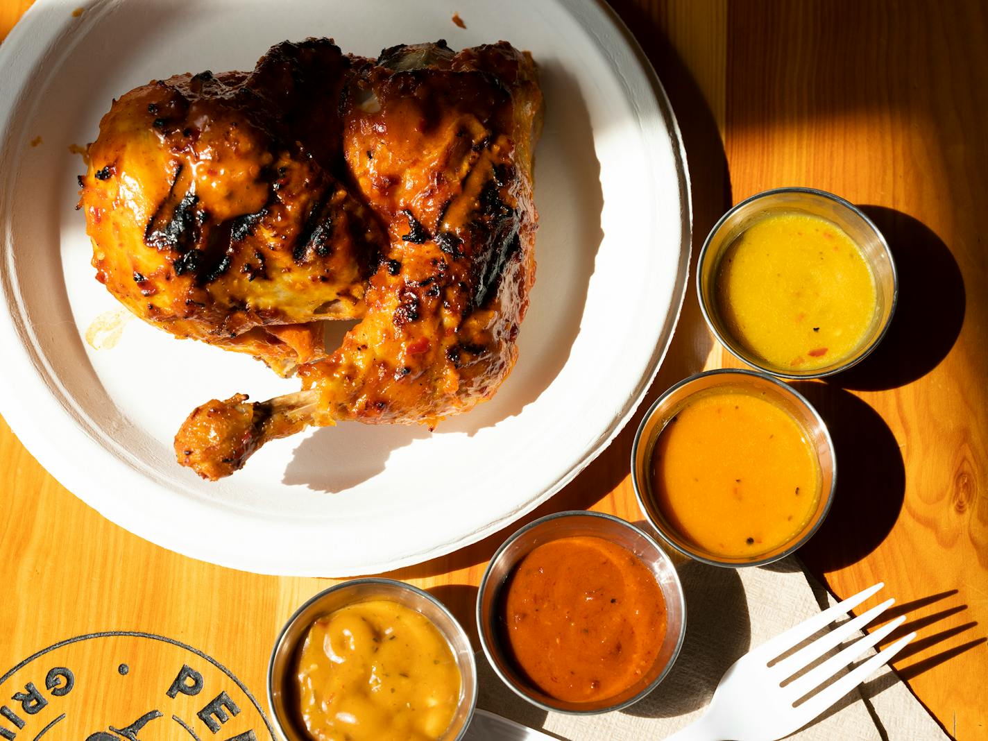 FILE — Peri Peri half chicken with house-made hot sauces at Piri Piri Grill House in Brooklyn, New York on June 8, 2019. Deeper and more complex use of heat will show up in restaurant dishes and at the grocery store. (Caitlin Ochs/The New York Times)