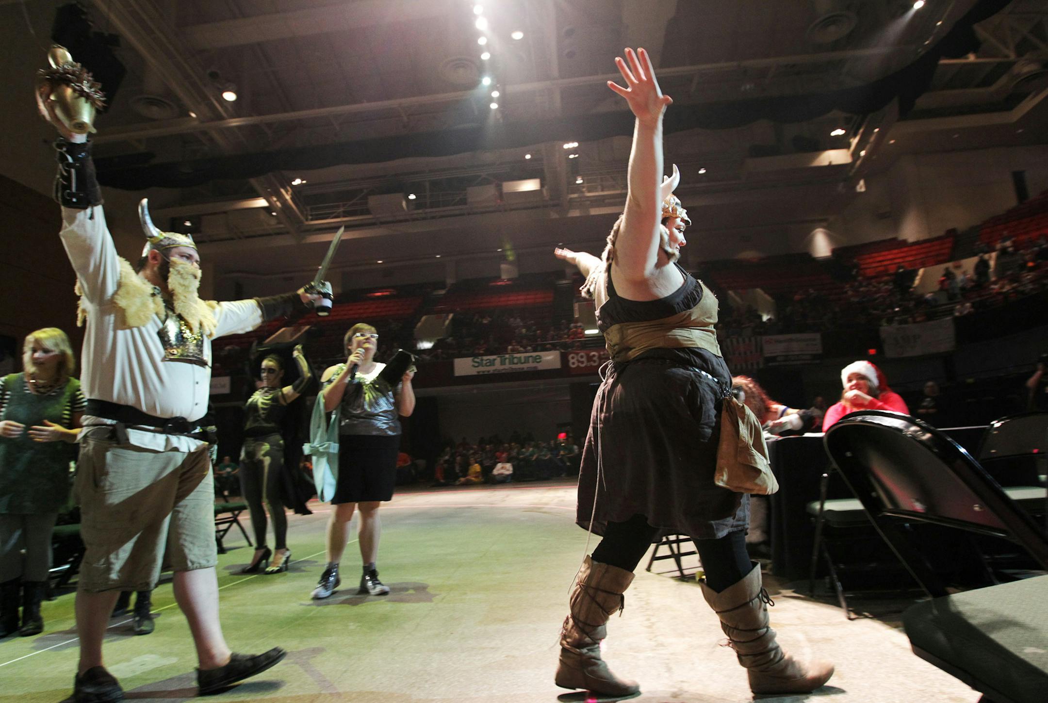 Linda Tyler, right, also known as "Helga Hammerfist," enters the arena with other members of the Minnesota Arm Wrestling League for Ladies as they put on a brief set of matches before the Minnesota Roller Girls tournament at Roy Wilkins Auditorium in St. Paul March 2, 2013. (Courtney Perry/Special to the Star Tribune)