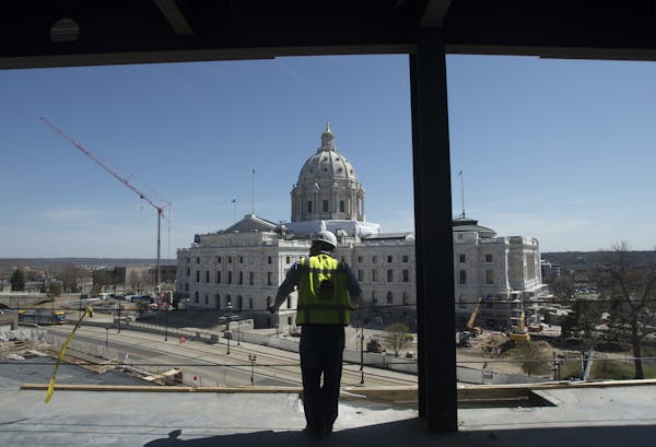 Greg Huber, senior project manager with Mortensen Construction overseeing the Senate Office Building project, looks on while standing on the top floor