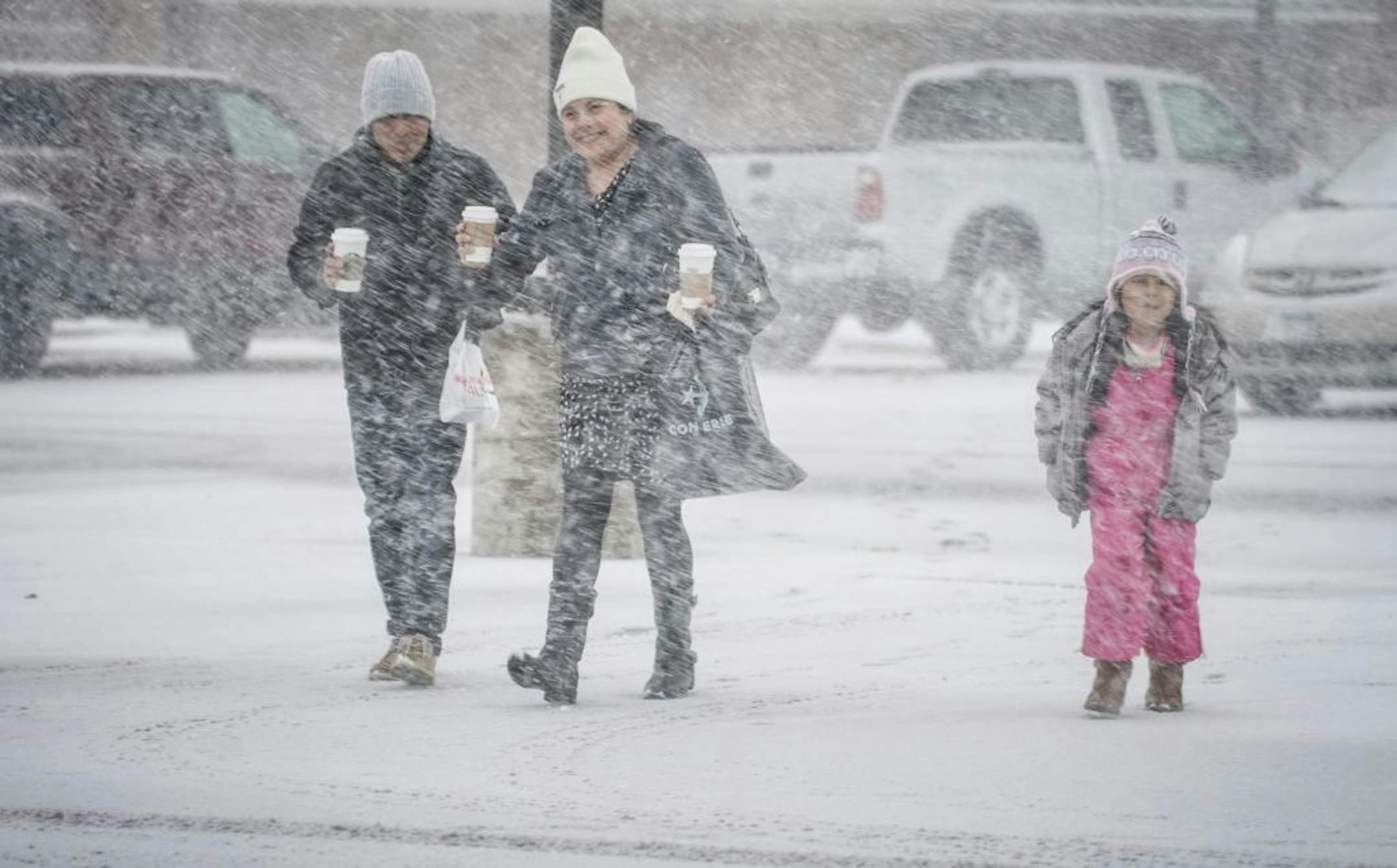 Juan, Maria and Juanita Ortiz didn't seem to mind the blowing snow in the parking lot of the Twin Cities Premium Outlets in Eagan.