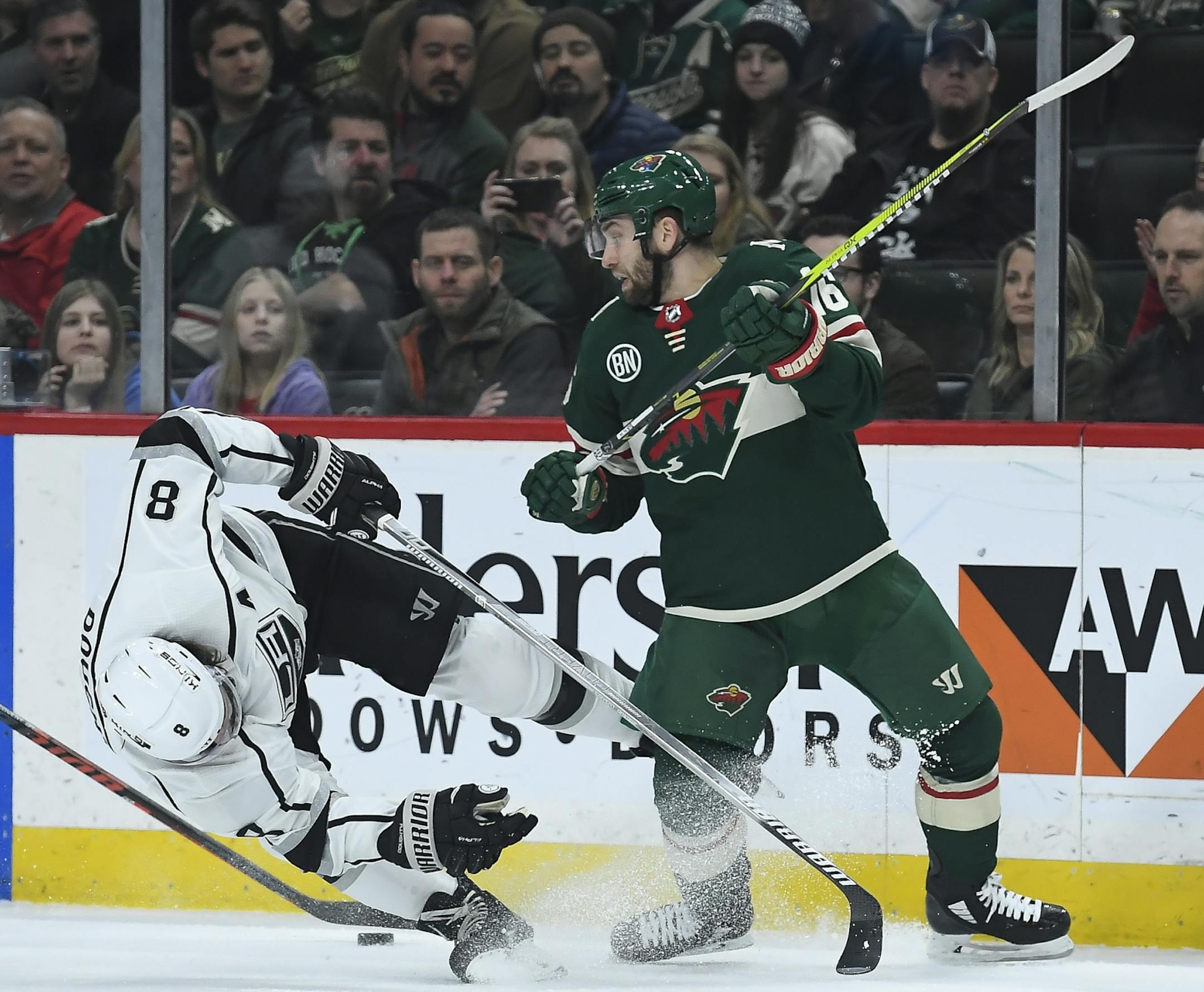 Los Angeles Kings defenseman Drew Doughty (8) fell to the ice after colliding with Minnesota Wild left wing Jason Zucker (16) in the first period.