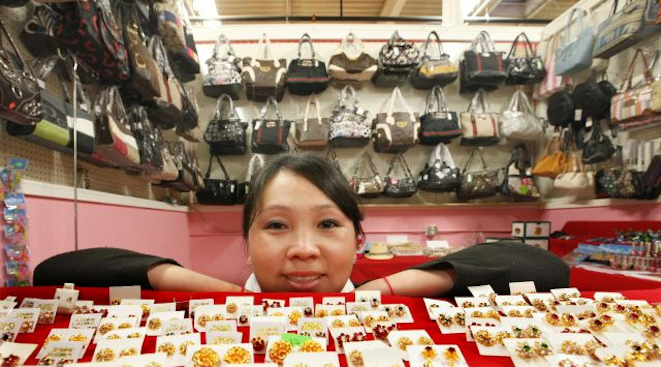 Soua Xiong sells purses, jewelry and other things for women for at her store in Hmong Village in St. Paul.