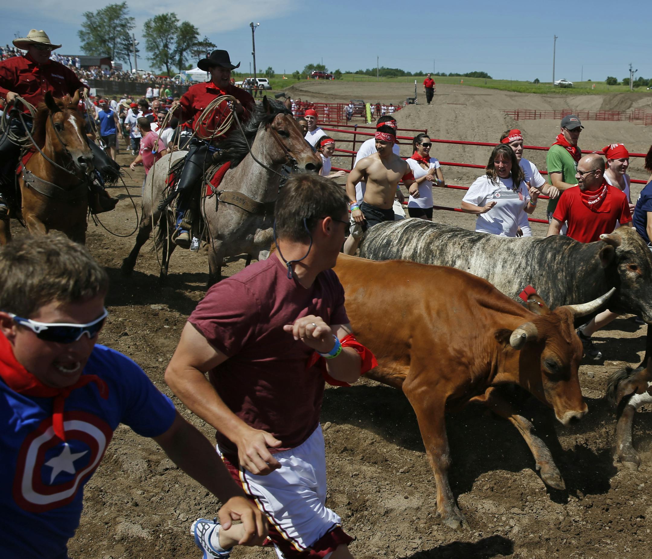 At the Great Bull Run held at the Elk River Extreme Motor Park, Minnesotans were able to run with the bulls on a quarter-mile course after being fortified with liquid courage, at least for some participants.] rtsong-taatarii@startribune.com
