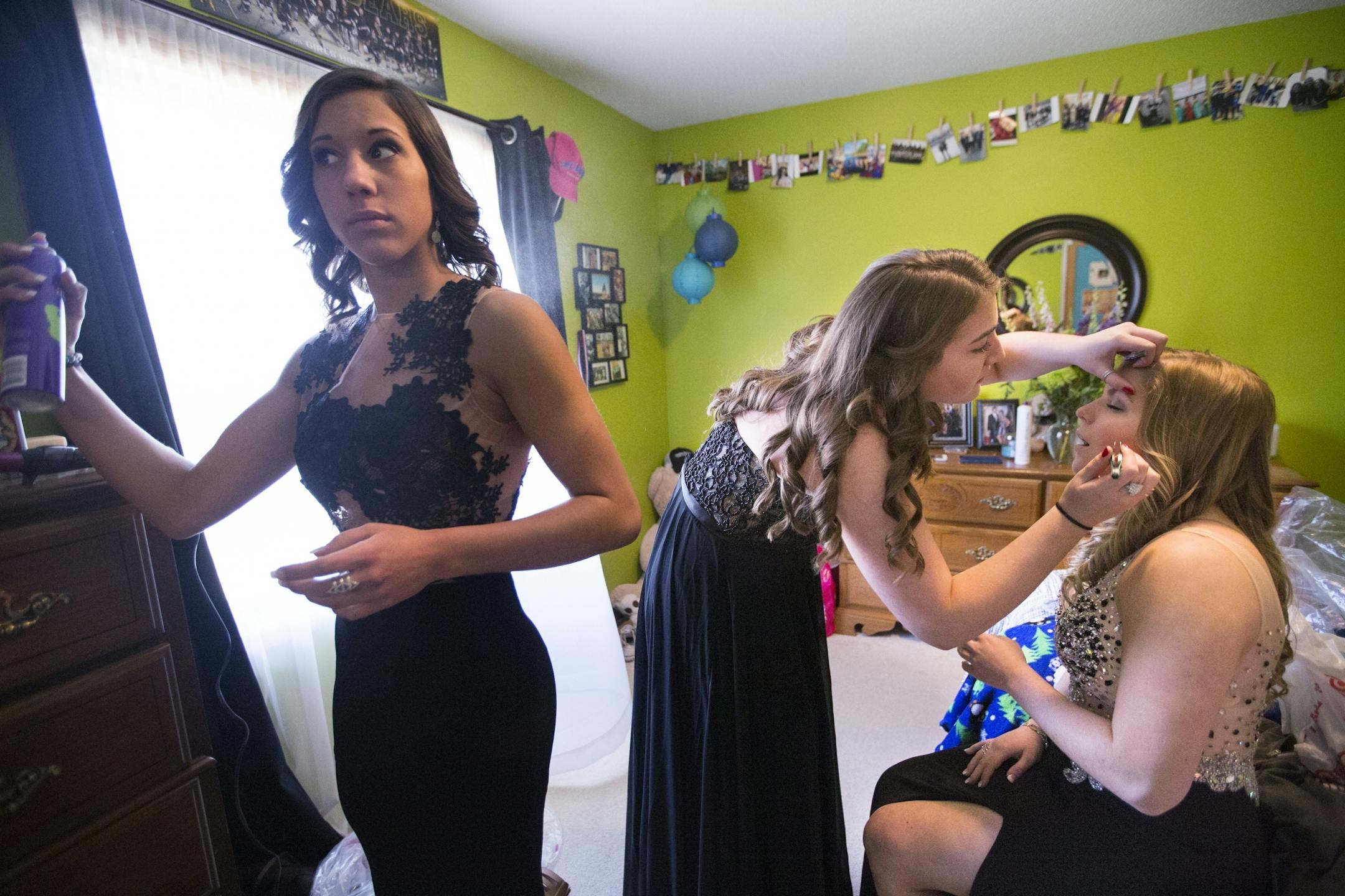 All seniors at Eveleth-Gilbert High School, Baylee Hilfers, from left, Logan Rozinka and Baylee Hanson get ready for prom in Hilfers' room in Fayal.