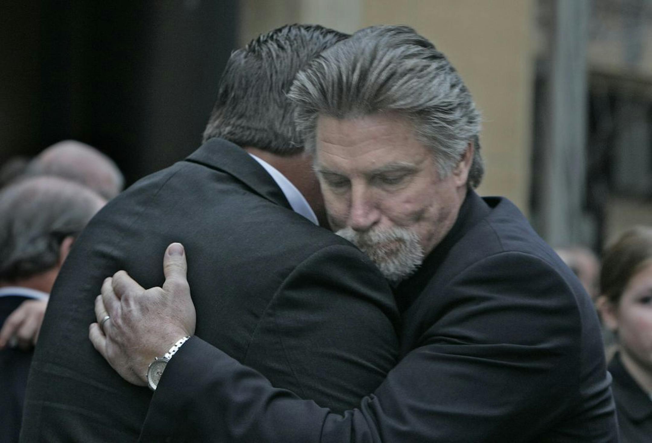 Kent Hrbek (left) and Jack Morris embrace following a funeral service for longtime Twins announcer Bob Casey that was held at St. Olaf Church in downtown Minneapolis.