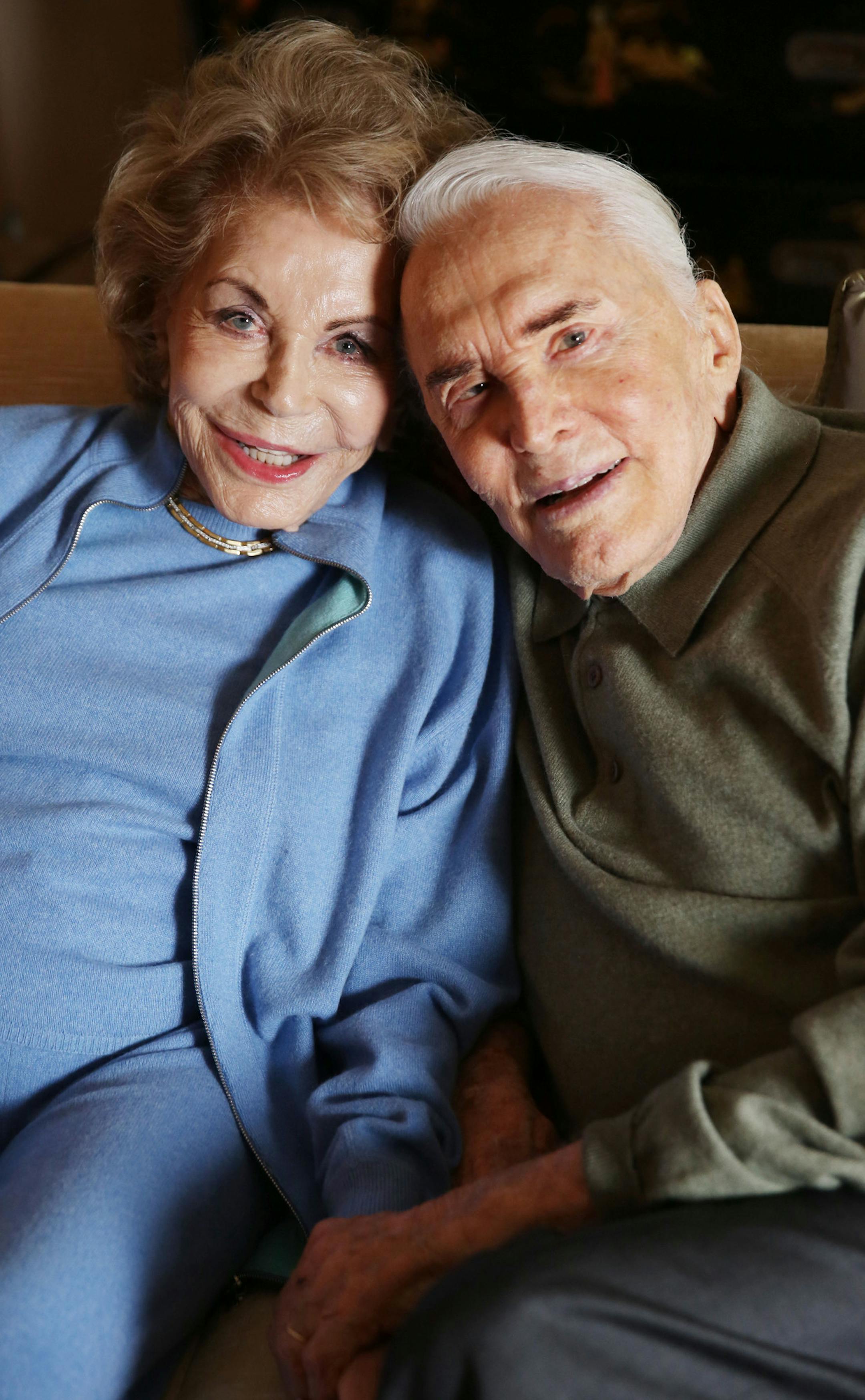 In this Friday, Dec. 5, 2014 photo, Kirk Douglas, right, and wife Anne Douglas pose for a portrait in Beverly Hills, Calif. The rakish screen legend with the famously dimpled chin made it abundantly clear that he was done with writing on a recent overcast afternoon at his Beverly Hills home, days before the release of his poetry collection ìLife Could Be Verse: Reflections on Love, Loss, and What Really Matters.î ìTo me, this is my best book, and my last book,î said Douglas,