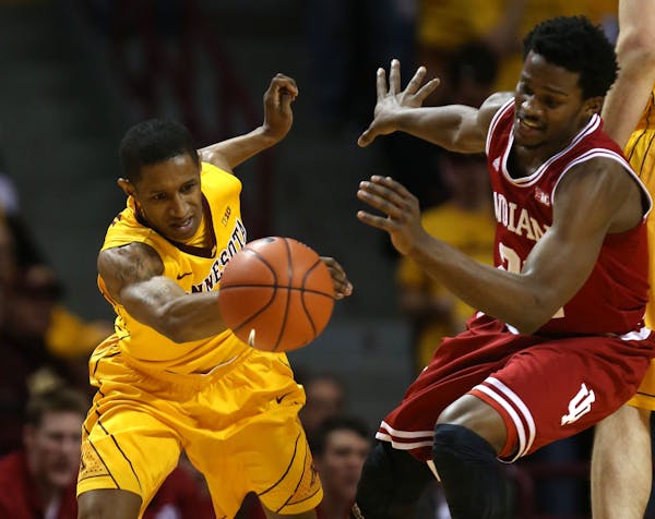 DeAndre Mathieu and Indiana's Stanford Robinson went after a loose ball during the first half at Williams Arena on Saturday, February 8, 2014.