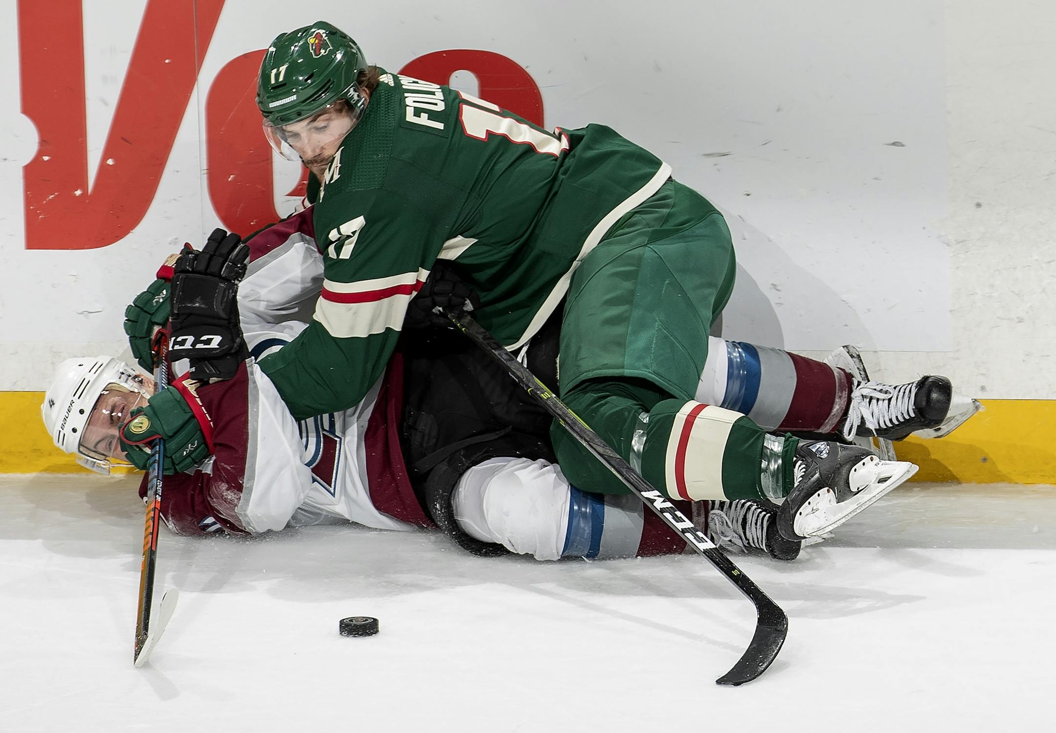 Marcus Foligno (17) and Tyson Barrie (4) fought for the puck in the second period.