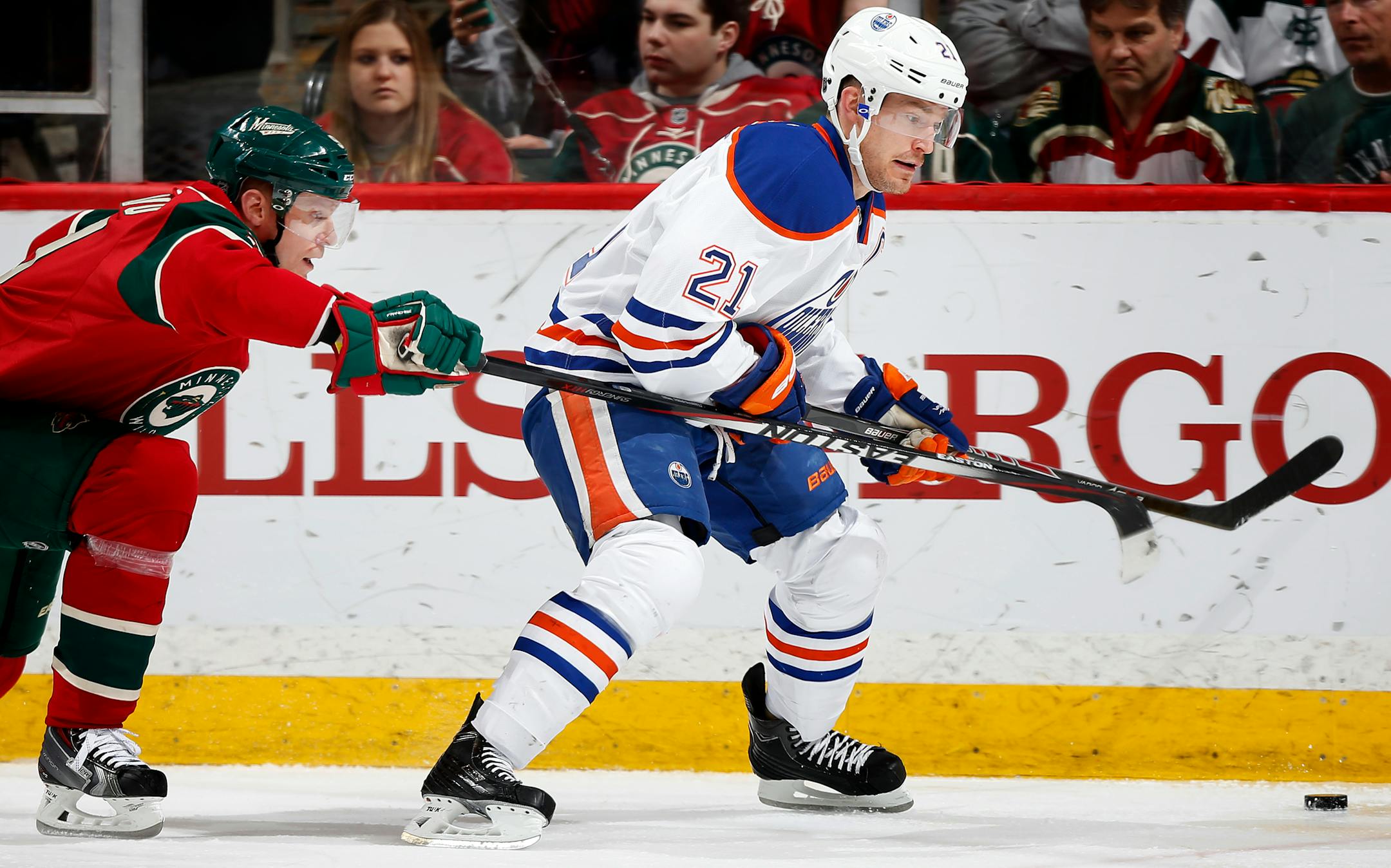 Mikko Koivu (9) and Andrew Ference (21) fought for the puck in the second period.