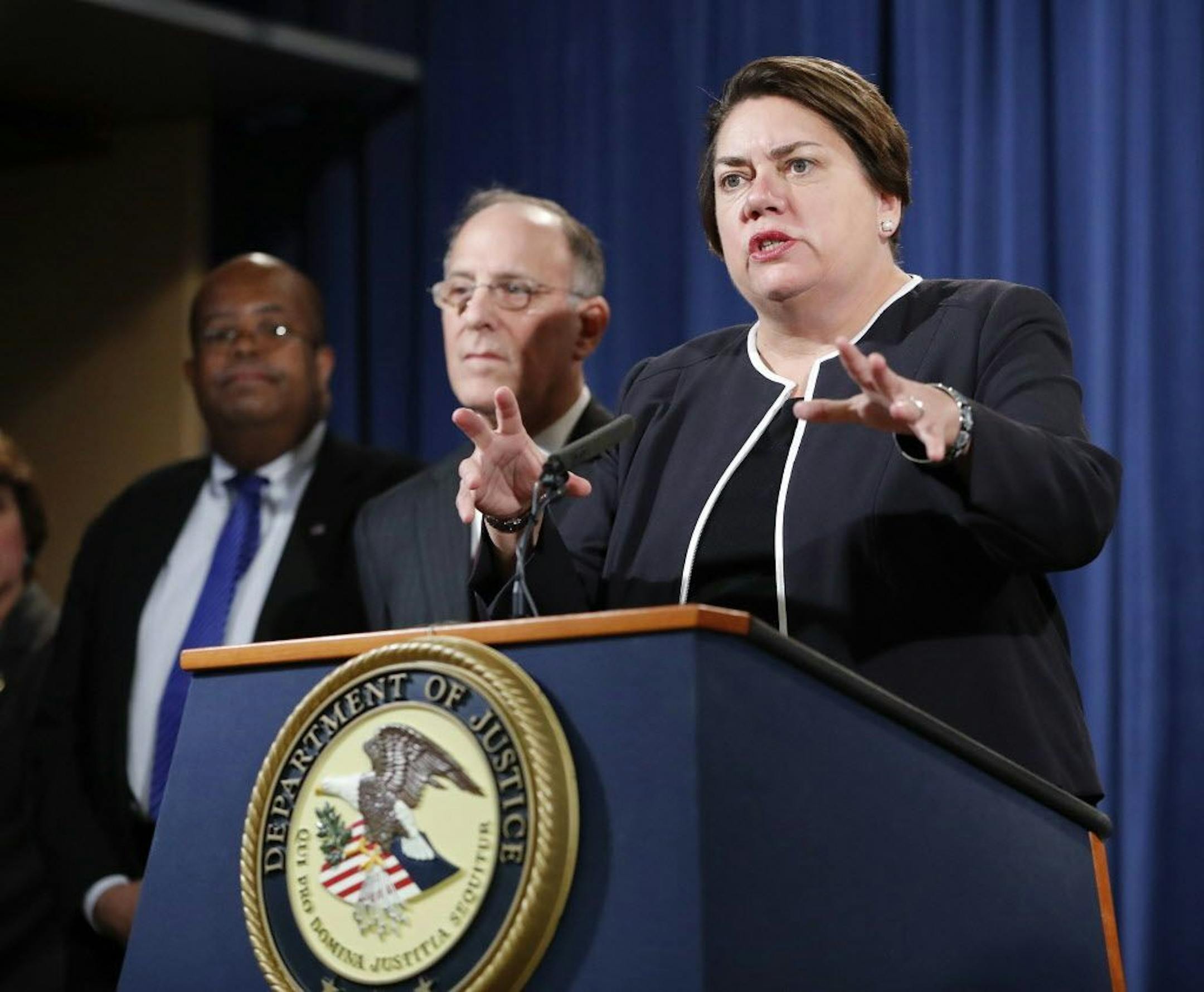 Assistant Attorney General Leslie R. Caldwell, right, of the Criminal Division, with Kenneth Magidson, center, of the Southern District of Texas; and U.S. Treasury Inspector General for Tax Administration J. Russell George, participate in a news conference at the Justice Department in Washington, Thursday, Oct. 27, 2016. Justice Department is announcing charges in connection with a call center operation said to be based in India. Federal prosecutors have unsealed an indictment charging 61 defend