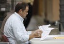 Employees looked through damaged ballots at the Supervisor of Elections office during a recount Thursday in West Palm Beach, Fla.