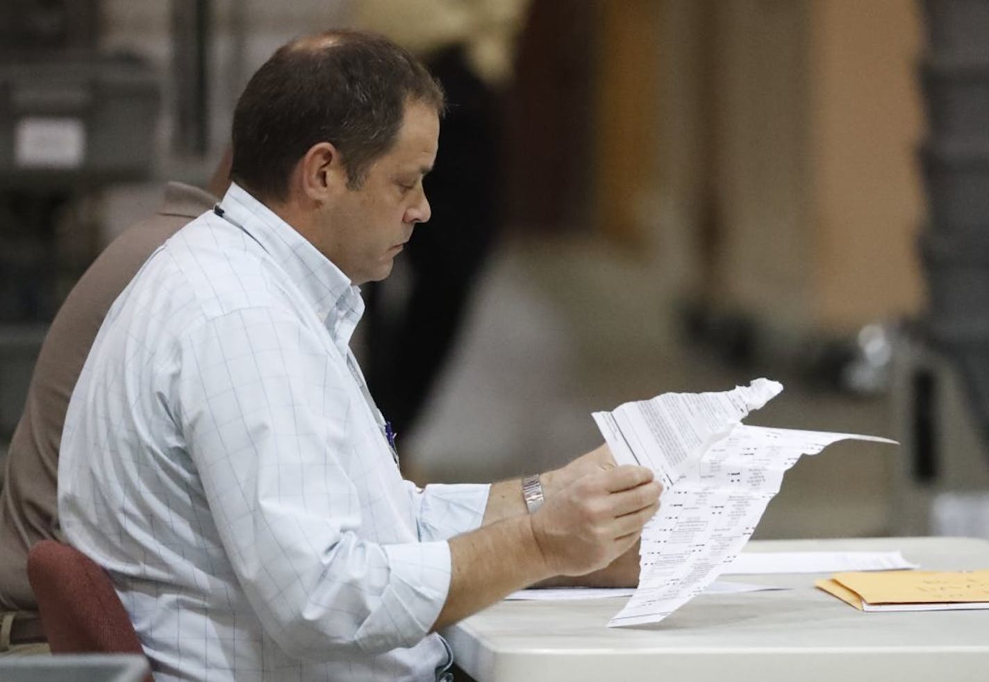 Employees looked through damaged ballots at the Supervisor of Elections office during a recount Thursday in West Palm Beach, Fla.