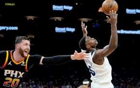 Suns center Jusuf Nurkic tries to defend Wolves guard Anthony Edwards on Friday night in Phoenix.