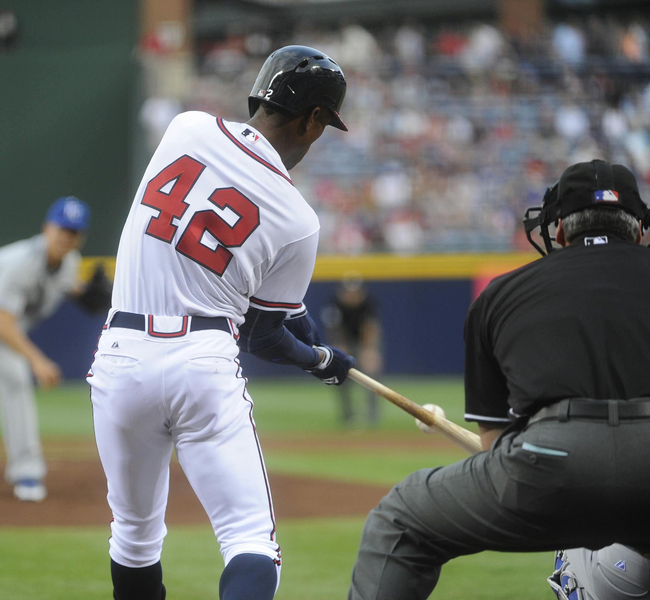 Atlanta Braves' B.J. Upton, wearing Jackie Robinson's number 42, puts the bat on the ball as Kansas City Royals starting pitcher Jeremy Guthrie delivers during the first inning of an MLB baseball game, Tuesday, April 16, 2013, in Atlanta. (AP Photo/John Amis)