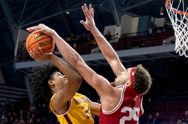 Jaden Henley (24) of the Minnesota Gophers is defended by Race Thompson (25) of the Indiana Hoosiers in the first half Wednesday, Jan. 25, 2023, at Wi