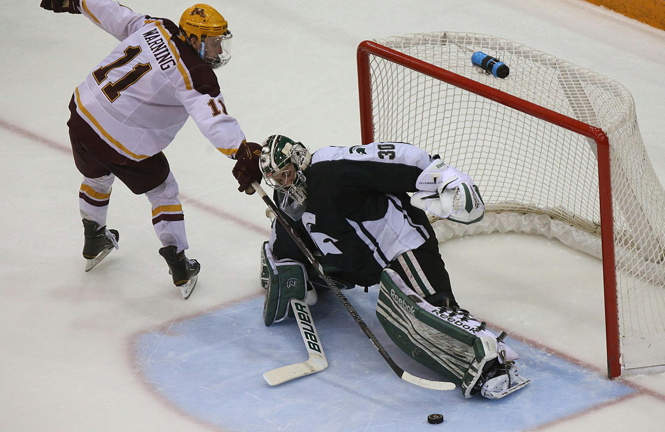 Michigan State goalie Jake Hildebrand stopped Minnesota‚Äôs Sam Warning in the overtime shootout to secure a shootout win for the Spartans. The two teams tied, 2-2 in regulation time. ] JIM GEHRZ ‚Ä¢ jgehrz@startribune.com / Minneapolis, MN / January 31, 2014 / 8:00 PM BACKGROUND INFORMATION: The Minnesota Golden Gophers men‚Äôs hockey team played the Michigan State Spartans at Mariucci Arena in Big Ten hockey action.