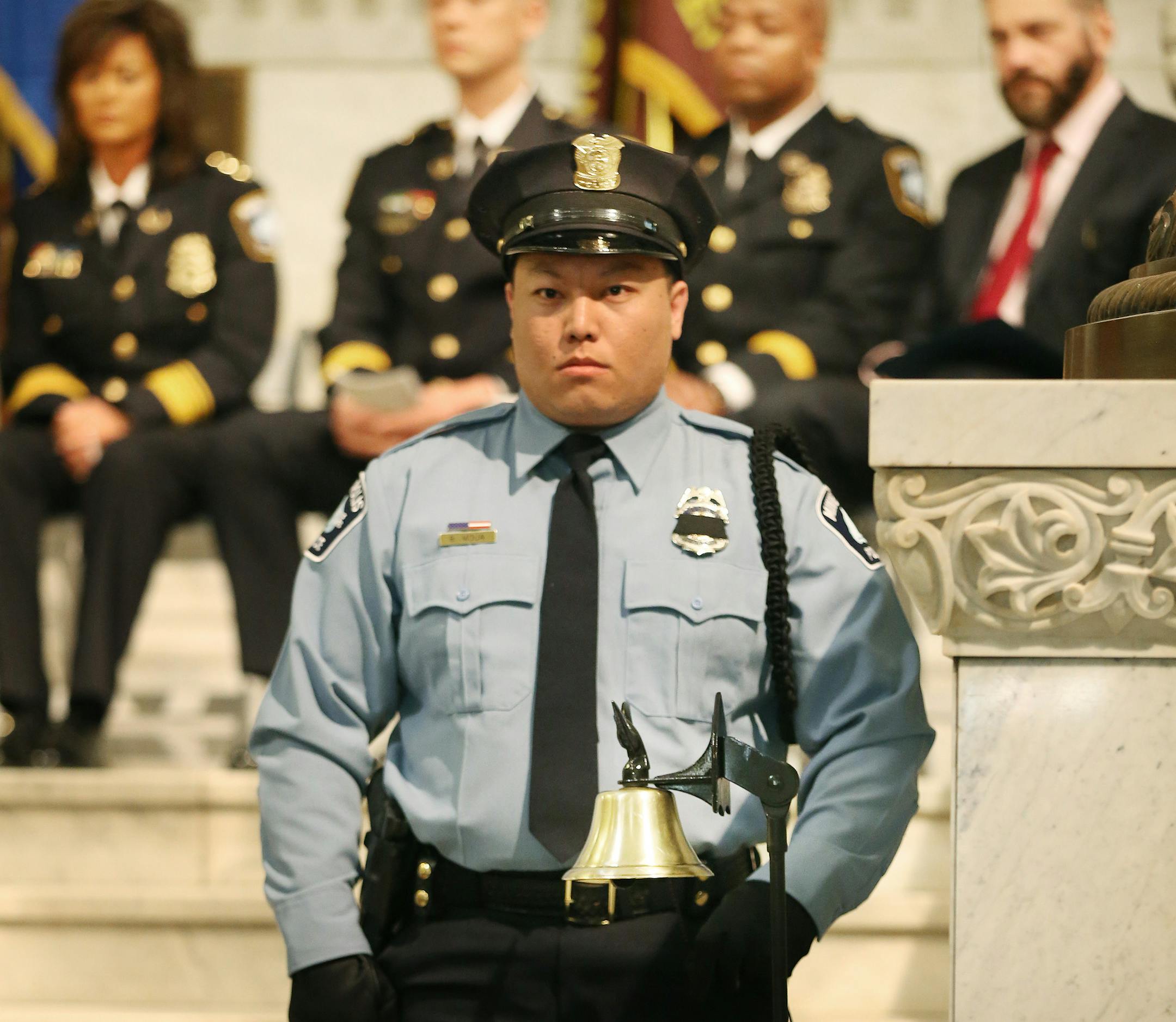 Minneapolis Police officer honor guard Blake Moua tolled the bell, as roll call of fallen officers was read Tuesday May 12, 2015 in Minneapolis, MN. In honor of National Police Week, Minneapolis Police Department and Hennepin County Sheriffs Office Law Enforcement will hold Memorial Ceremony.] Jerry Holt/ Jerry.Holt@Startribune.com