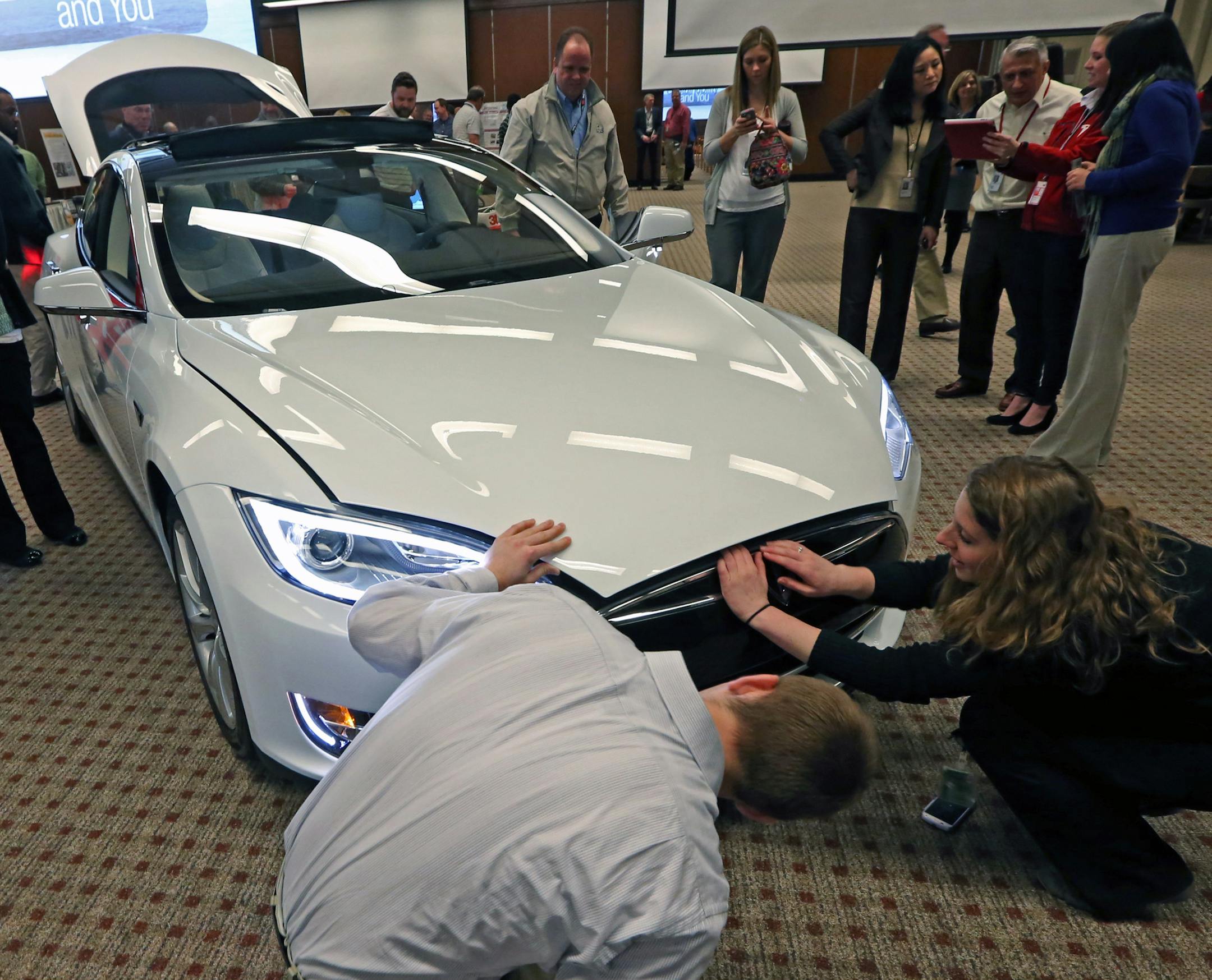 3M employees looked at the Tesla S electric car as part of the 3M celebration of Earth Day with displays of other sustainable 3M products including Novec Enginered Fluids, LED lighting and 3M window films, on 4/22/14 at 3M headquarters in Maplewood. 3M also received an award from the EPA for its work in energy efficiency.] Bruce Bisping/Star Tribune bbisping@startribune.com