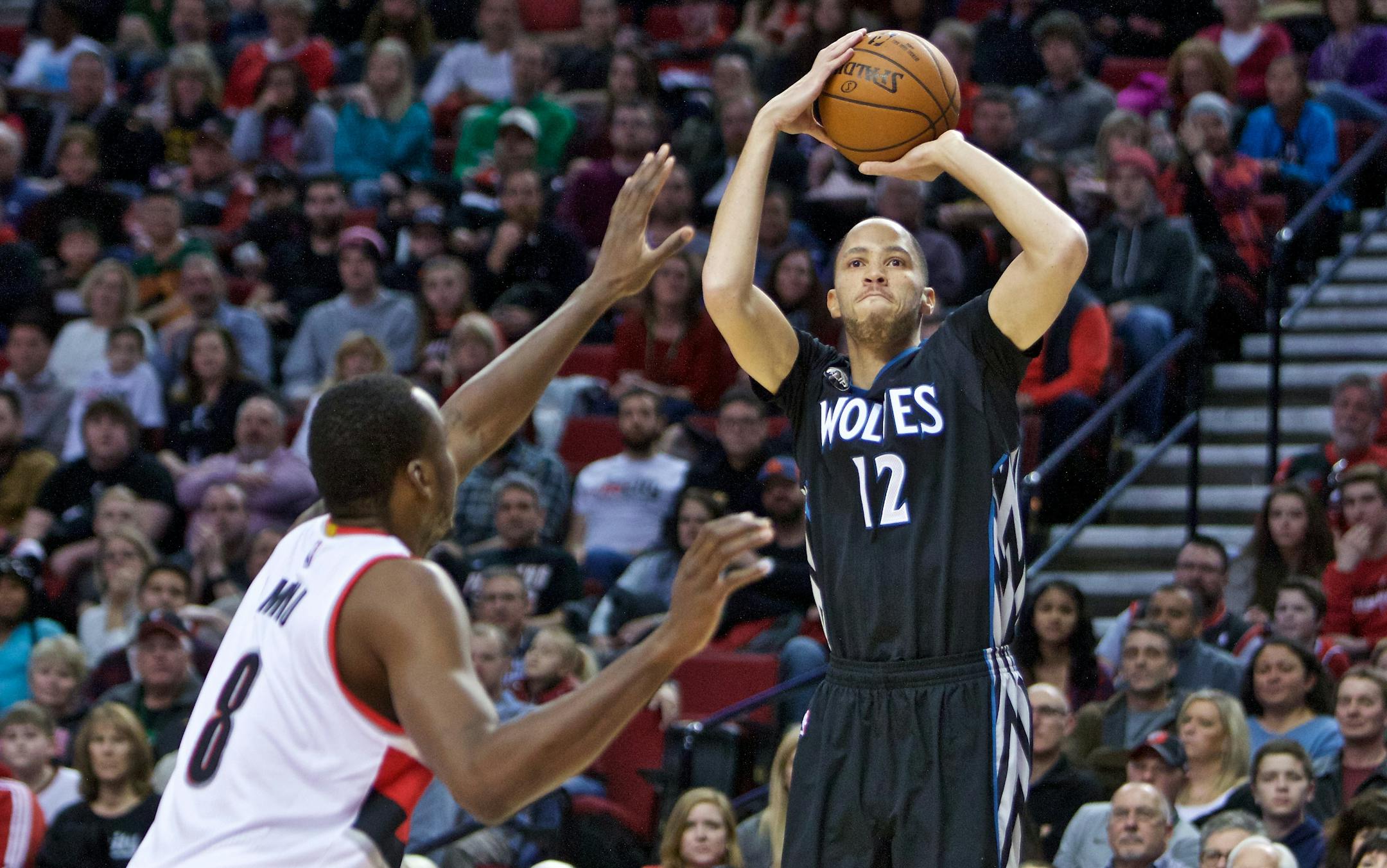 Minnesota Timberwolves forward Tayshaun Prince, right, shoots over Portland Trail Blazers forward Al-Farouq Aminu, left, during the first half of an NBA basketball game in Portland, Ore., Sunday, Jan. 31, 2016. (AP Photo/Craig Mitchelldyer)