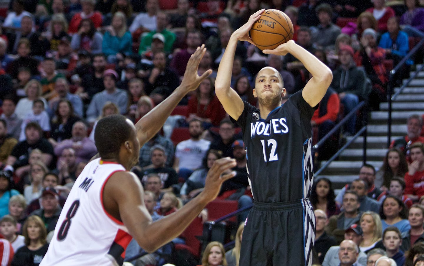 Minnesota Timberwolves forward Tayshaun Prince, right, shoots over Portland Trail Blazers forward Al-Farouq Aminu, left, during the first half of an NBA basketball game in Portland, Ore., Sunday, Jan. 31, 2016. (AP Photo/Craig Mitchelldyer)