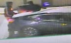 Surveillance images shows what police say are suspects loading a Caribou Coffee safe into a car outside Eden Prairie Center.